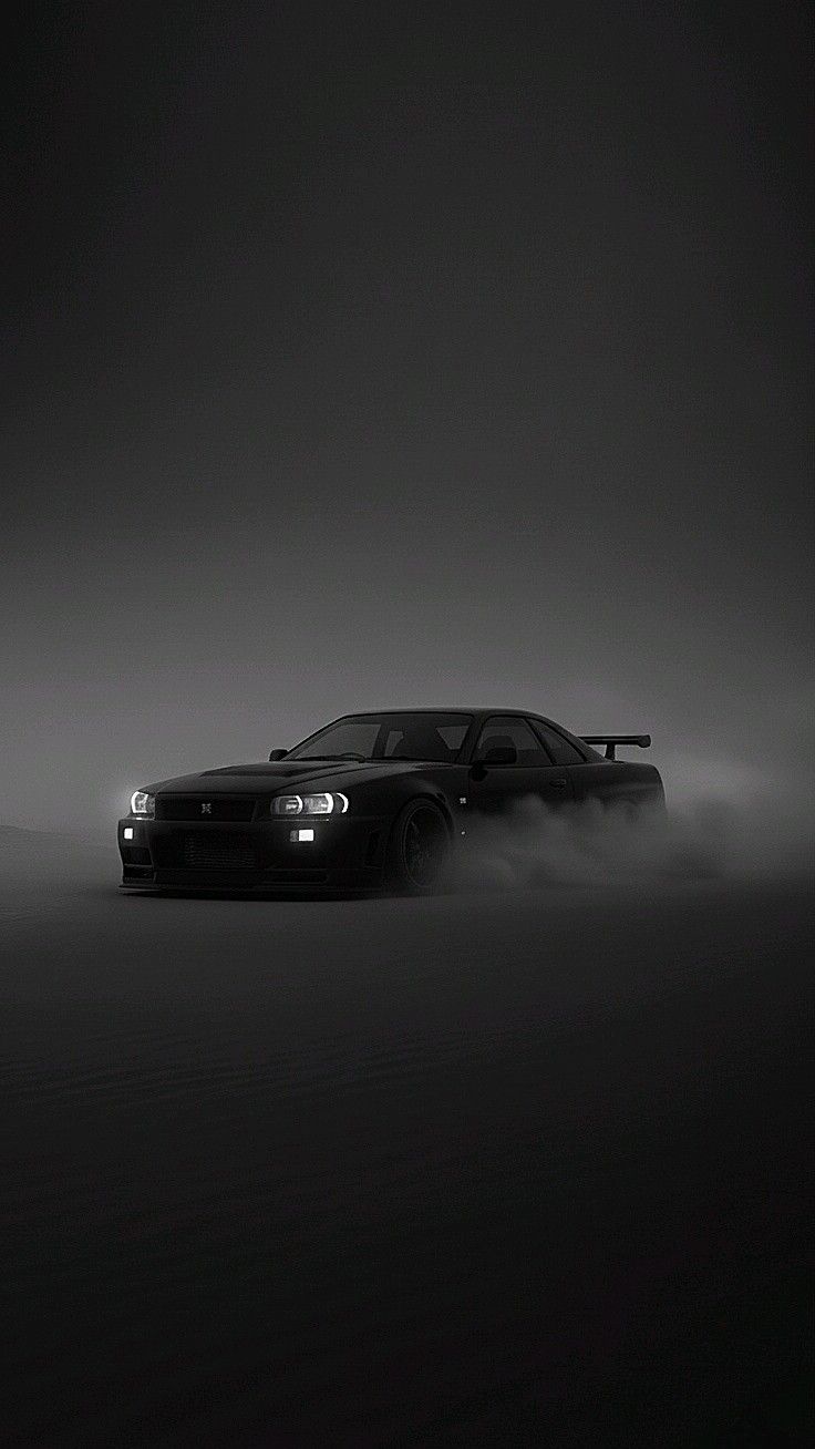 a black and white photo of a car in the fog