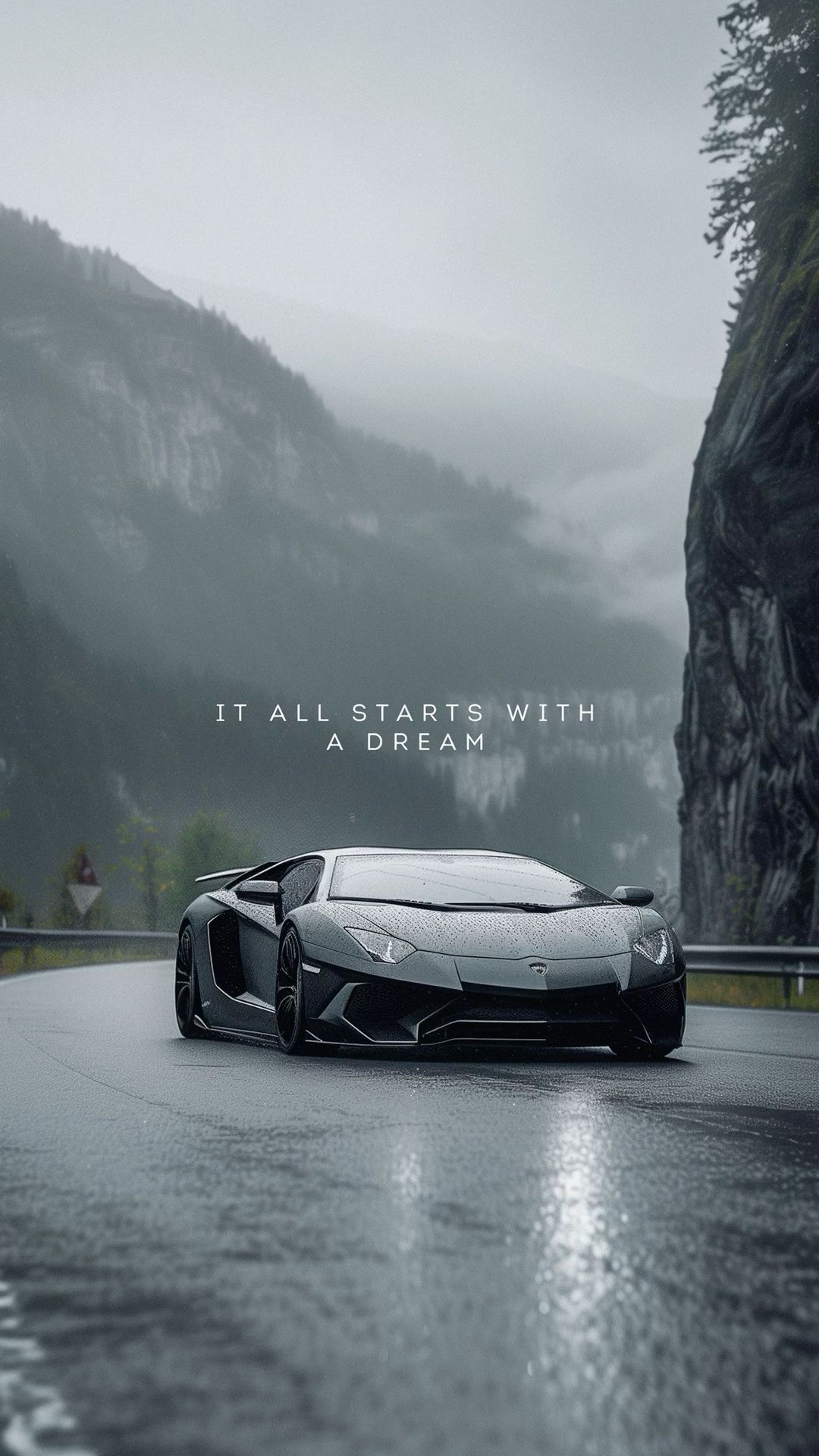 a black and white photo of a sports car on a road with mountains in the background