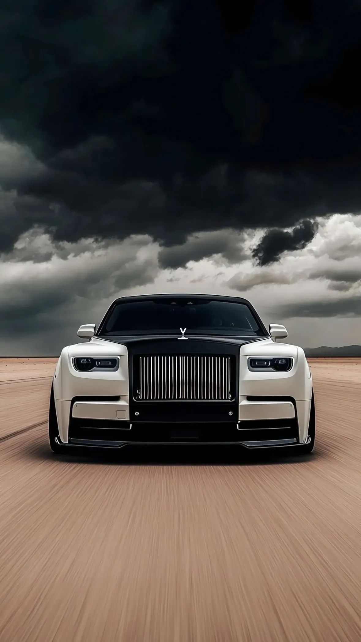a black and white rolls royce driving down the road in front of some dark clouds