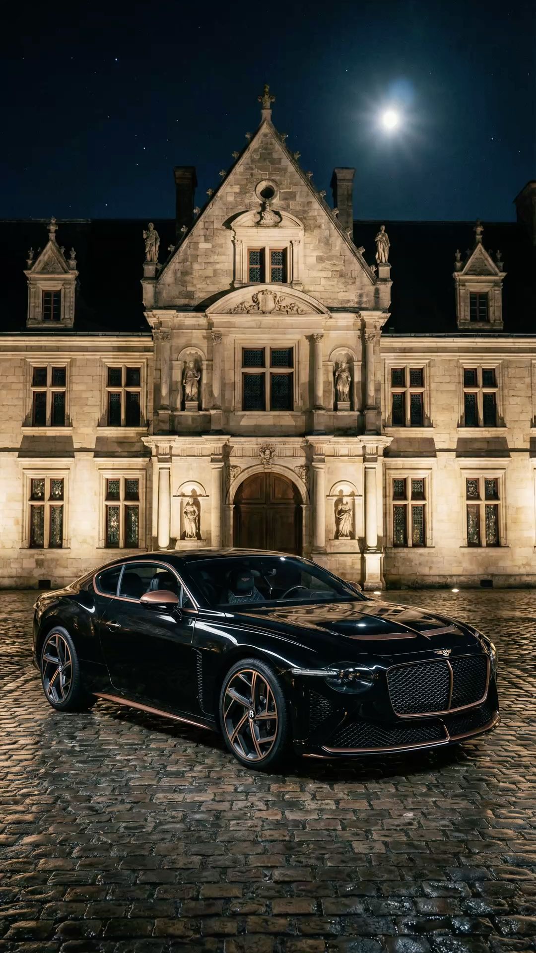 a black car parked in front of a large building at night with the moon shining
