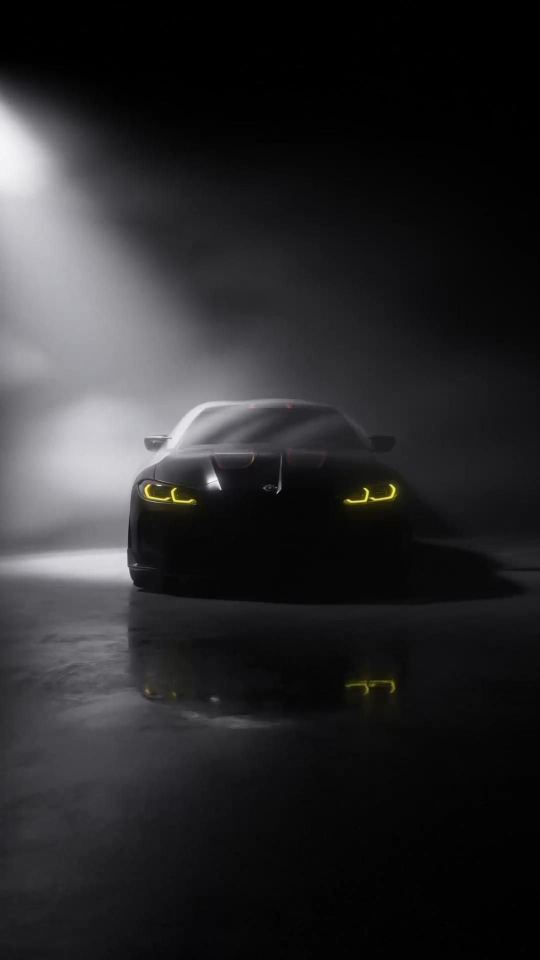 a black sports car in the dark with fog and light coming from its hoods