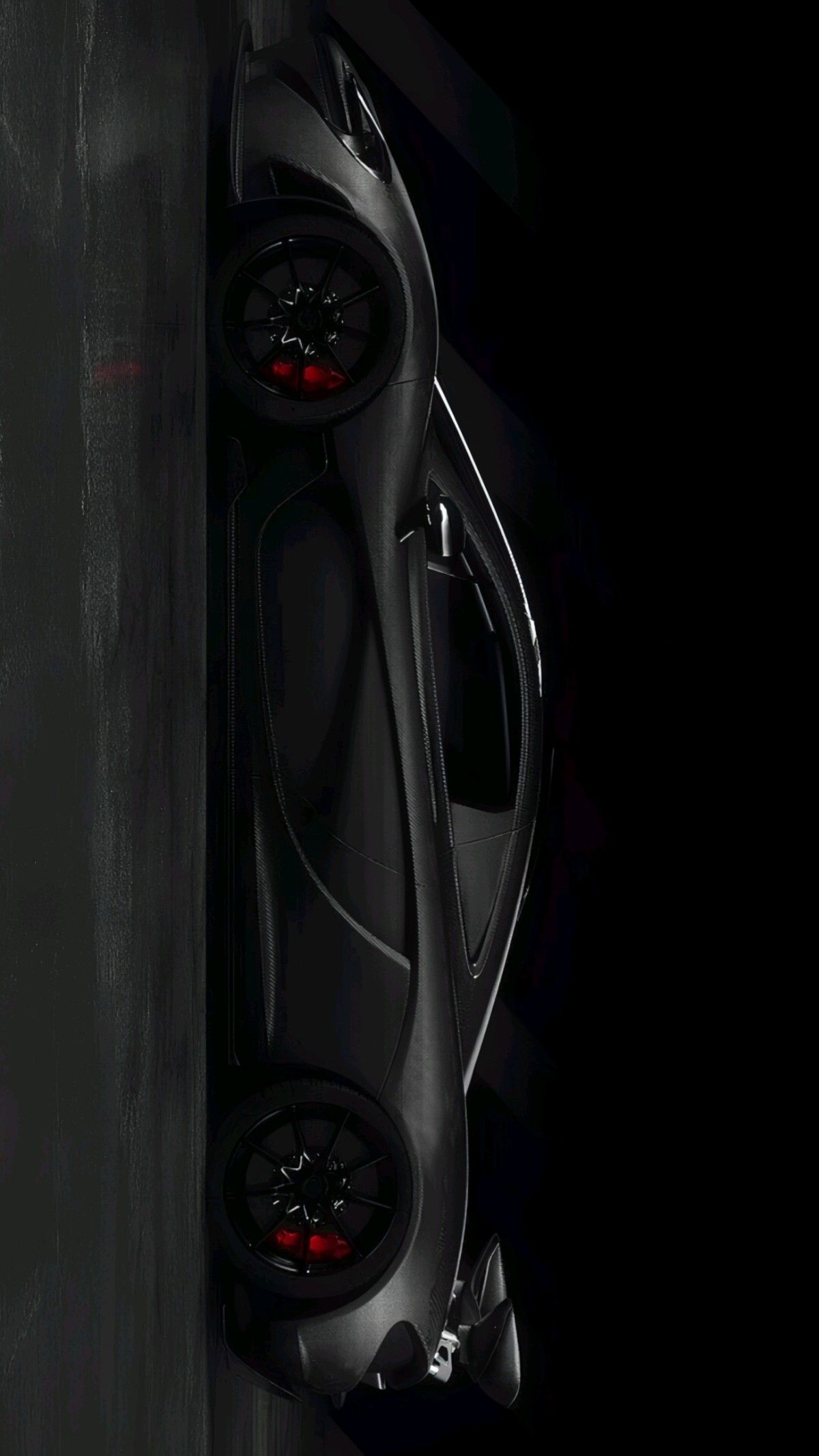 a black sports car is shown from above in this artistic photo, it appears to be dark