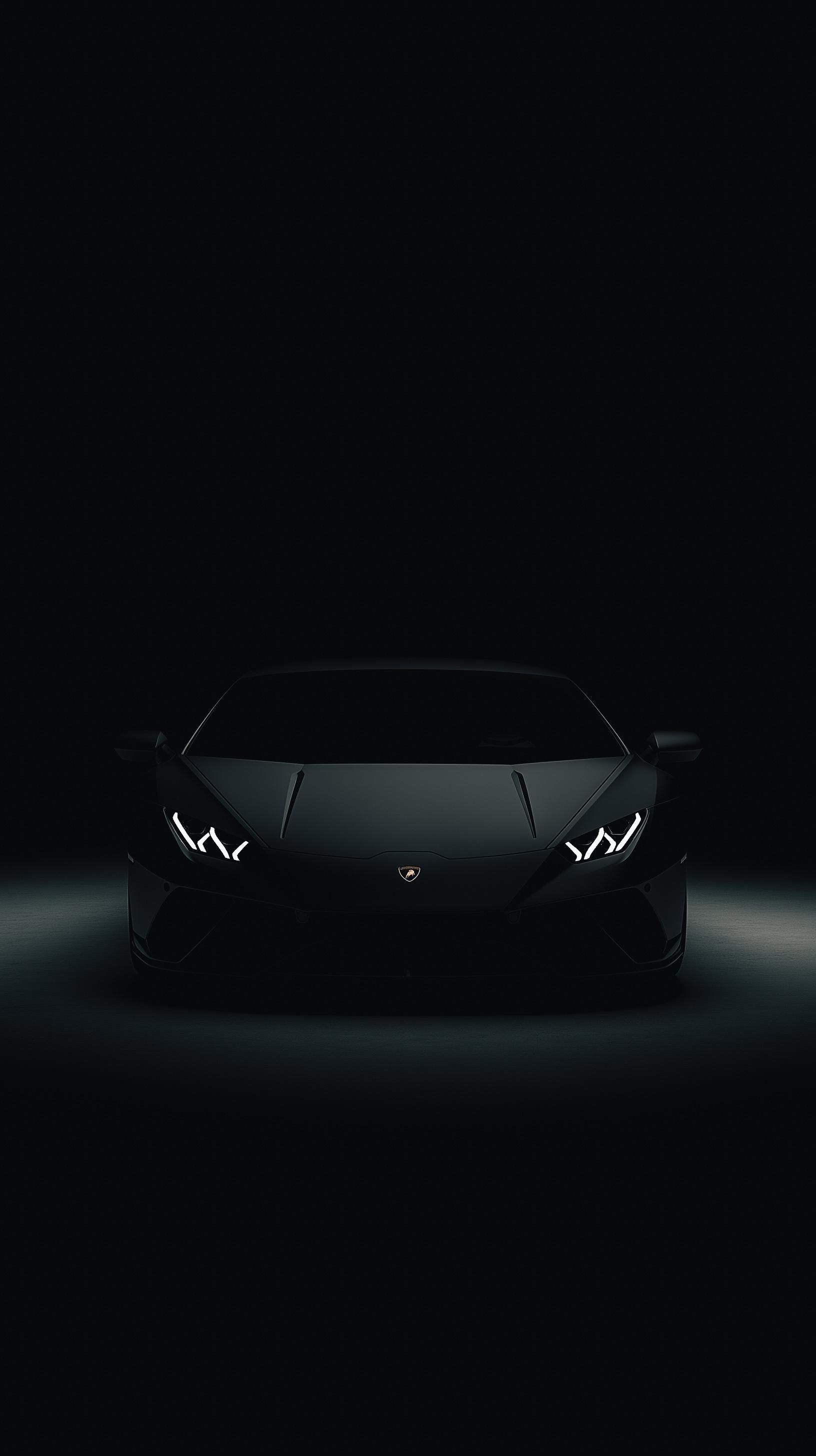 a black sports car is shown in the dark