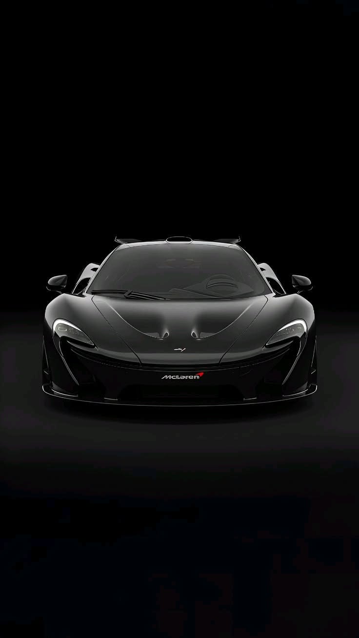 a black sports car is shown in the dark