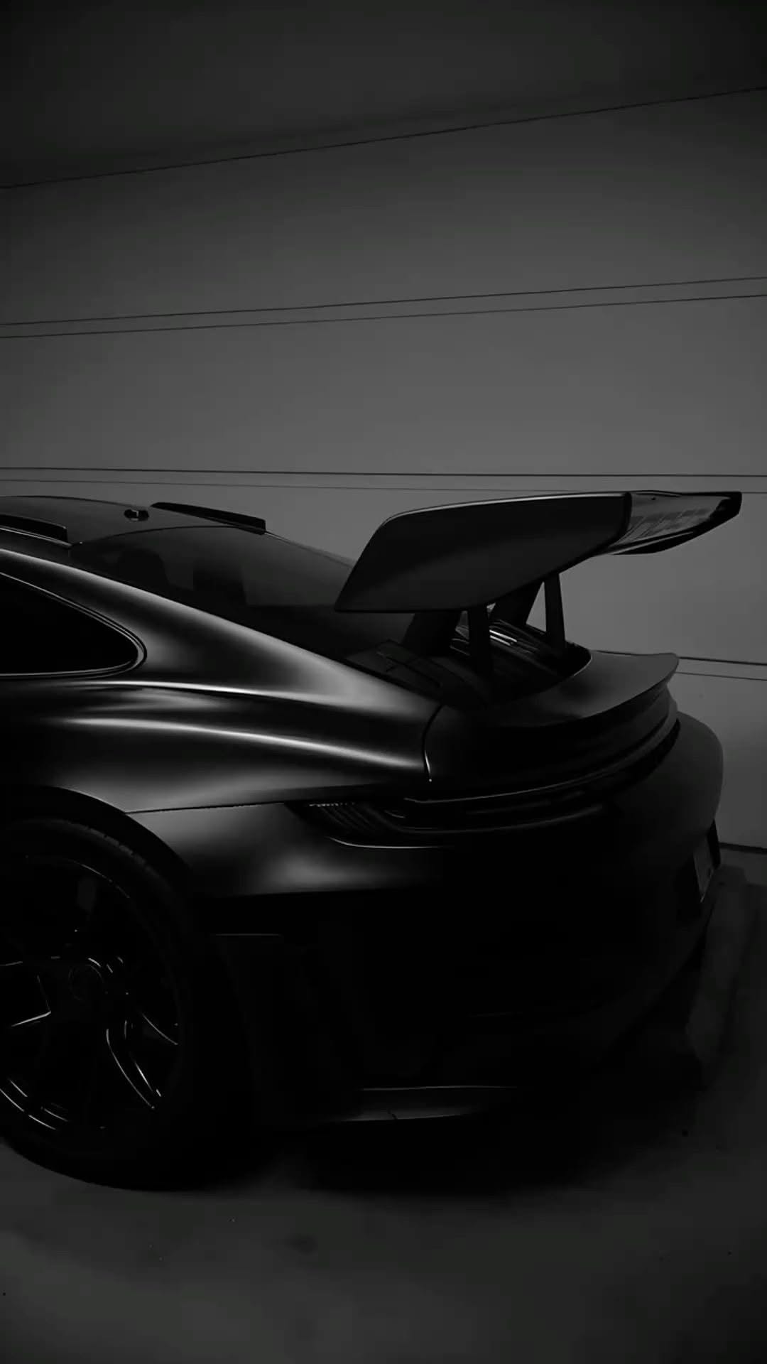 a black sports car parked in a garage