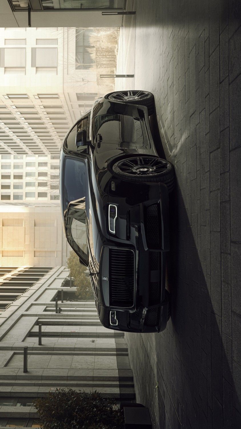 a black sports car parked on the side of a building