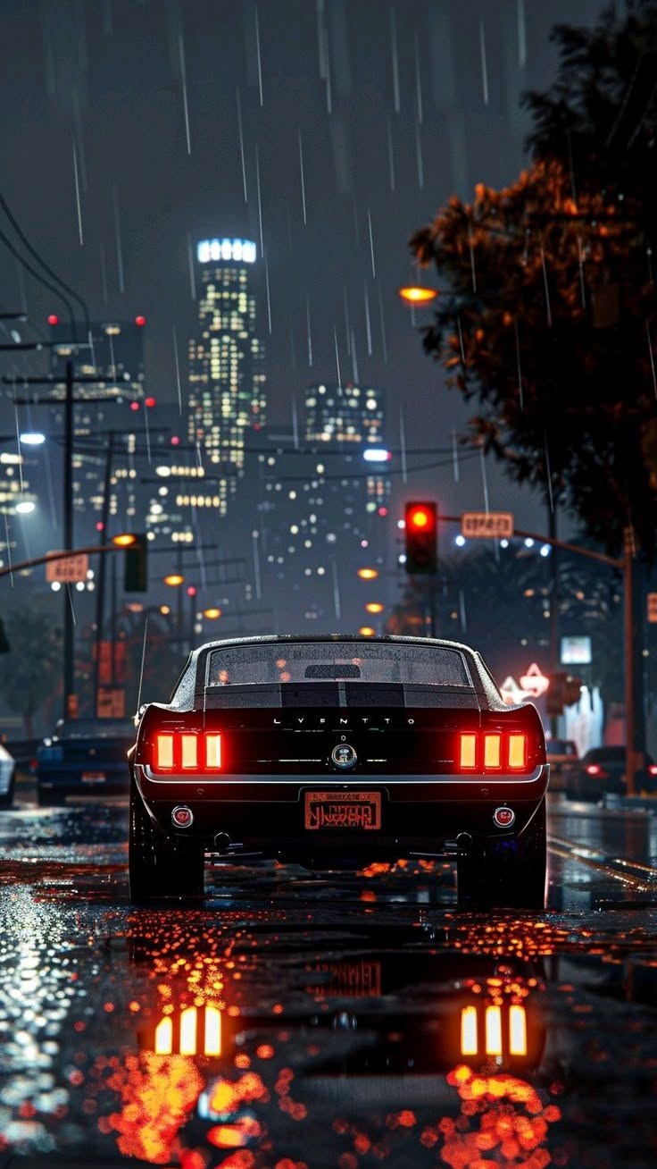 a car is driving through the rain at night with its lights on and buildings in the background