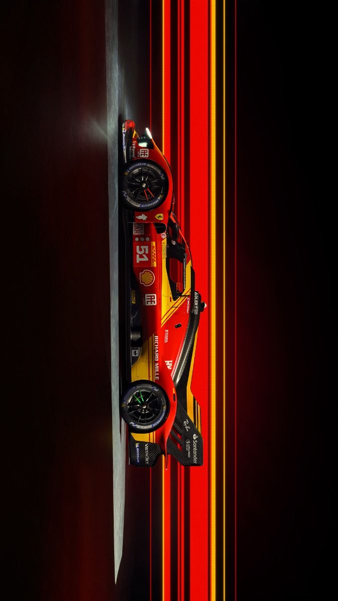 a red and yellow race car sitting on top of a wall