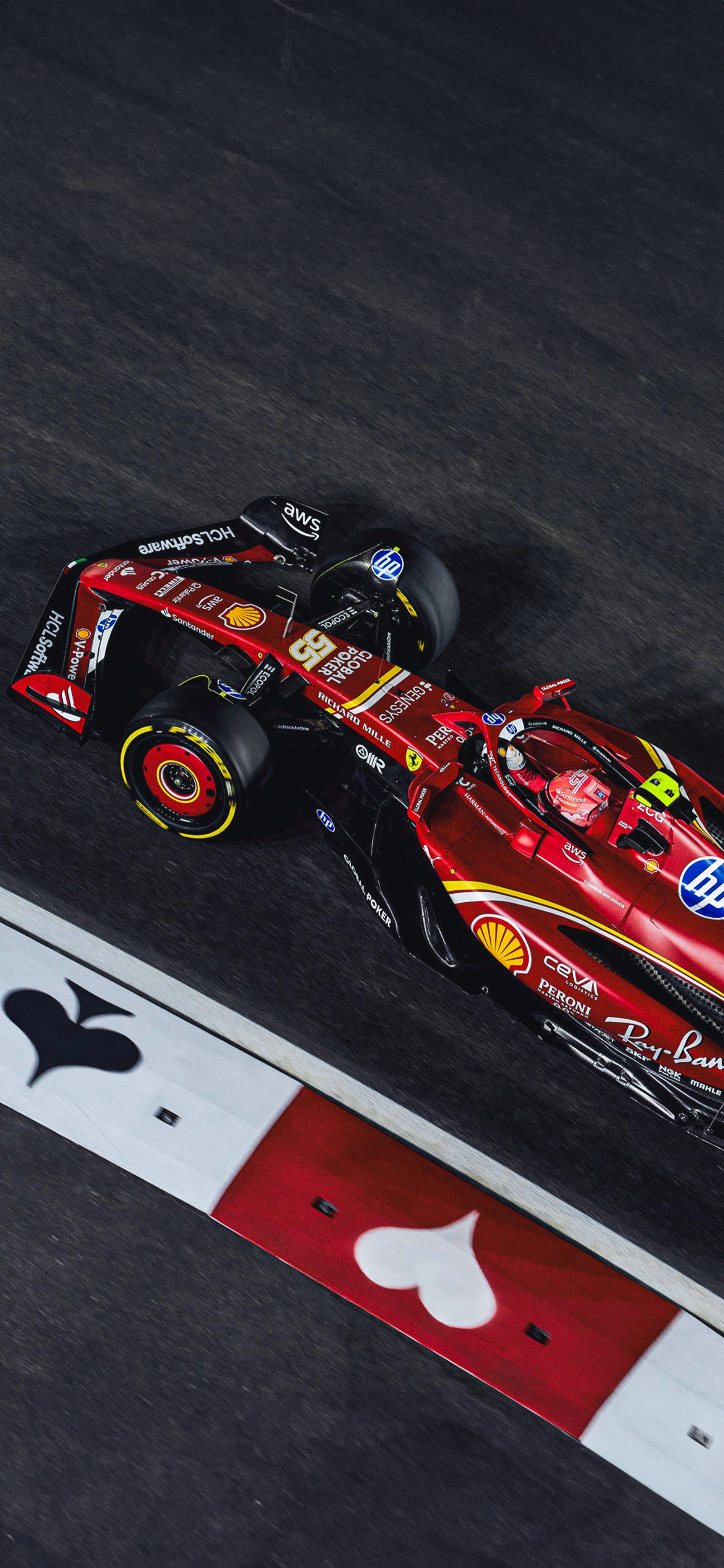 a red race car driving down the track