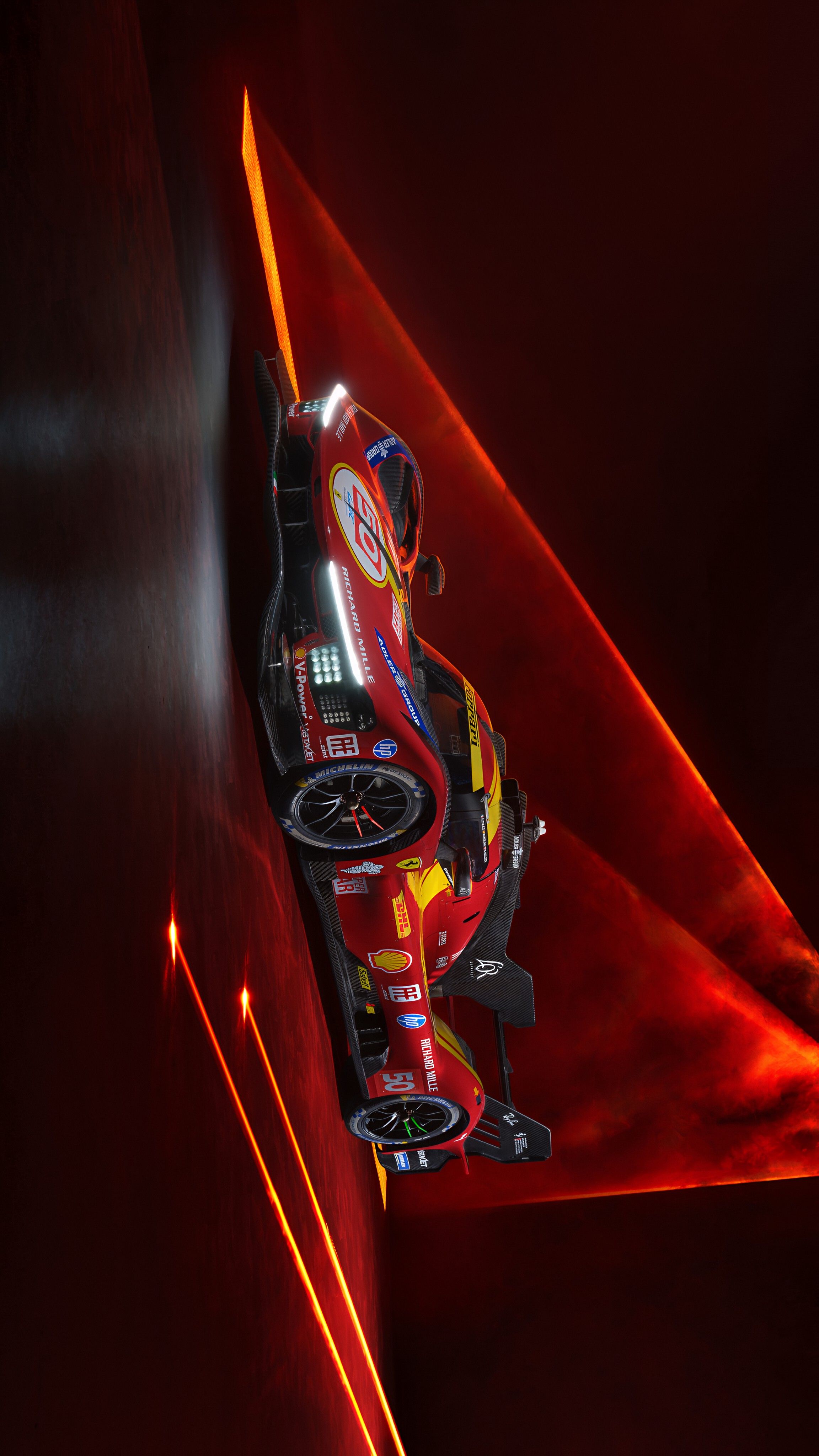 a red race car driving through a tunnel with bright lights on the walls behind it
