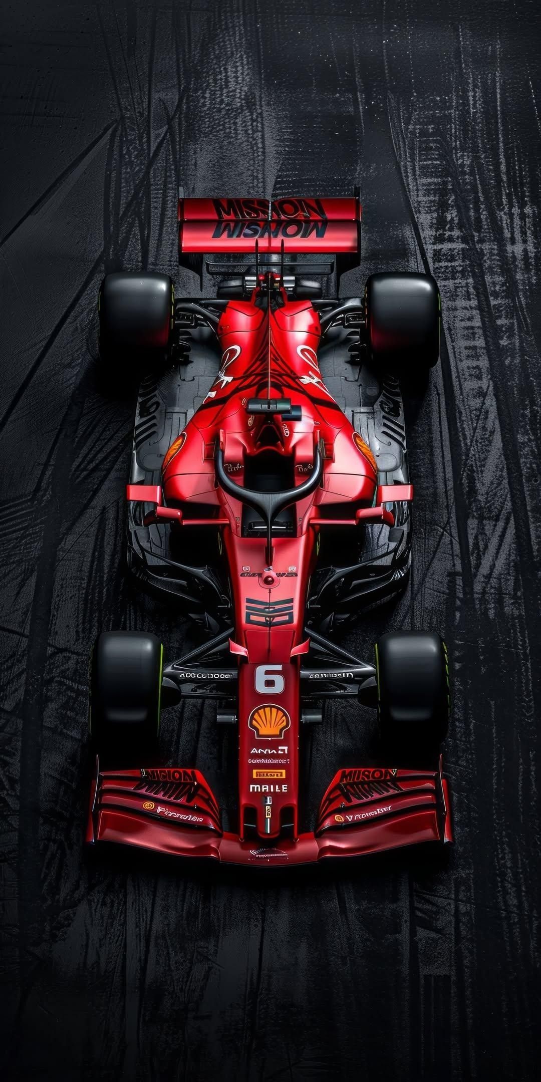 a red race car is shown from above, on a black and grey background with the word ferrari written across it