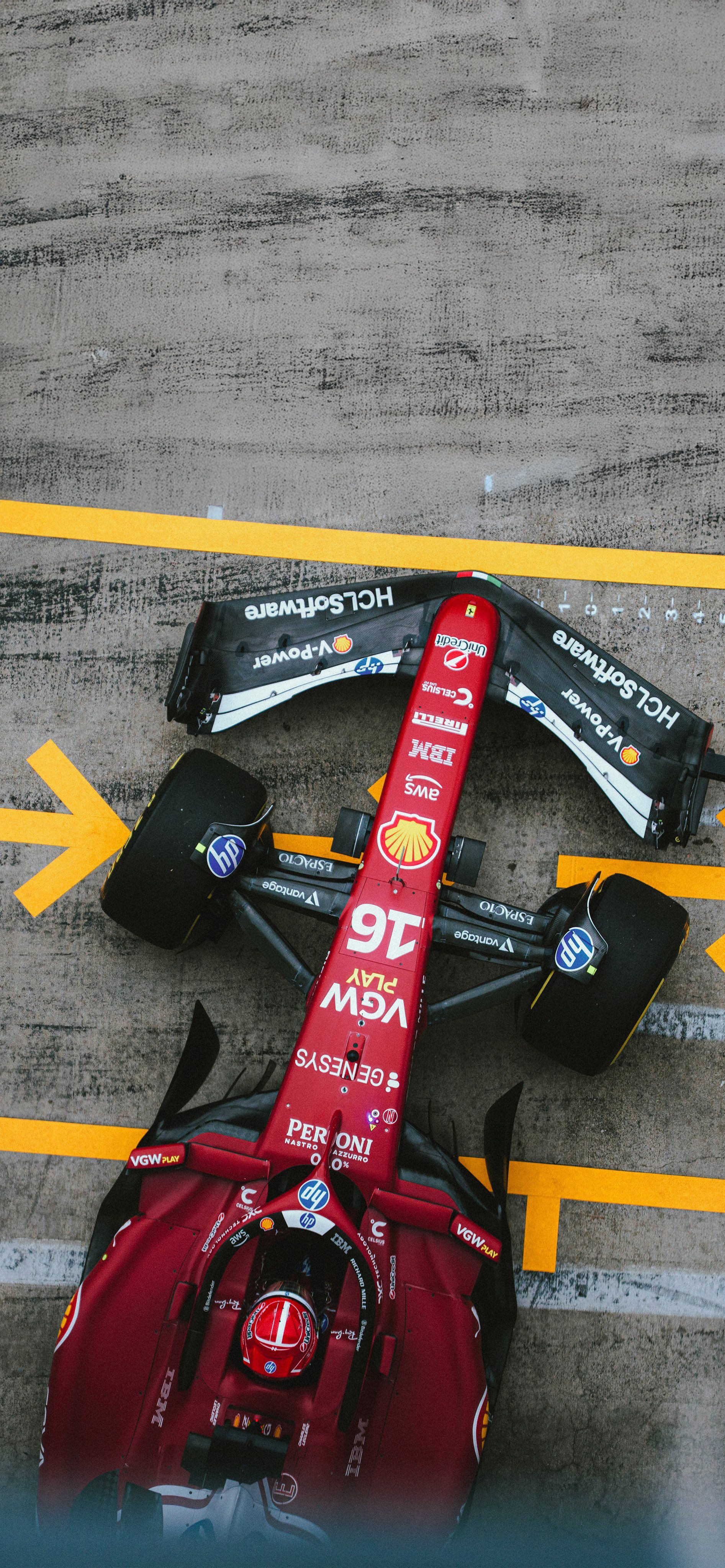 a red race car sits on the ground next to an arrow pointing in opposite directions