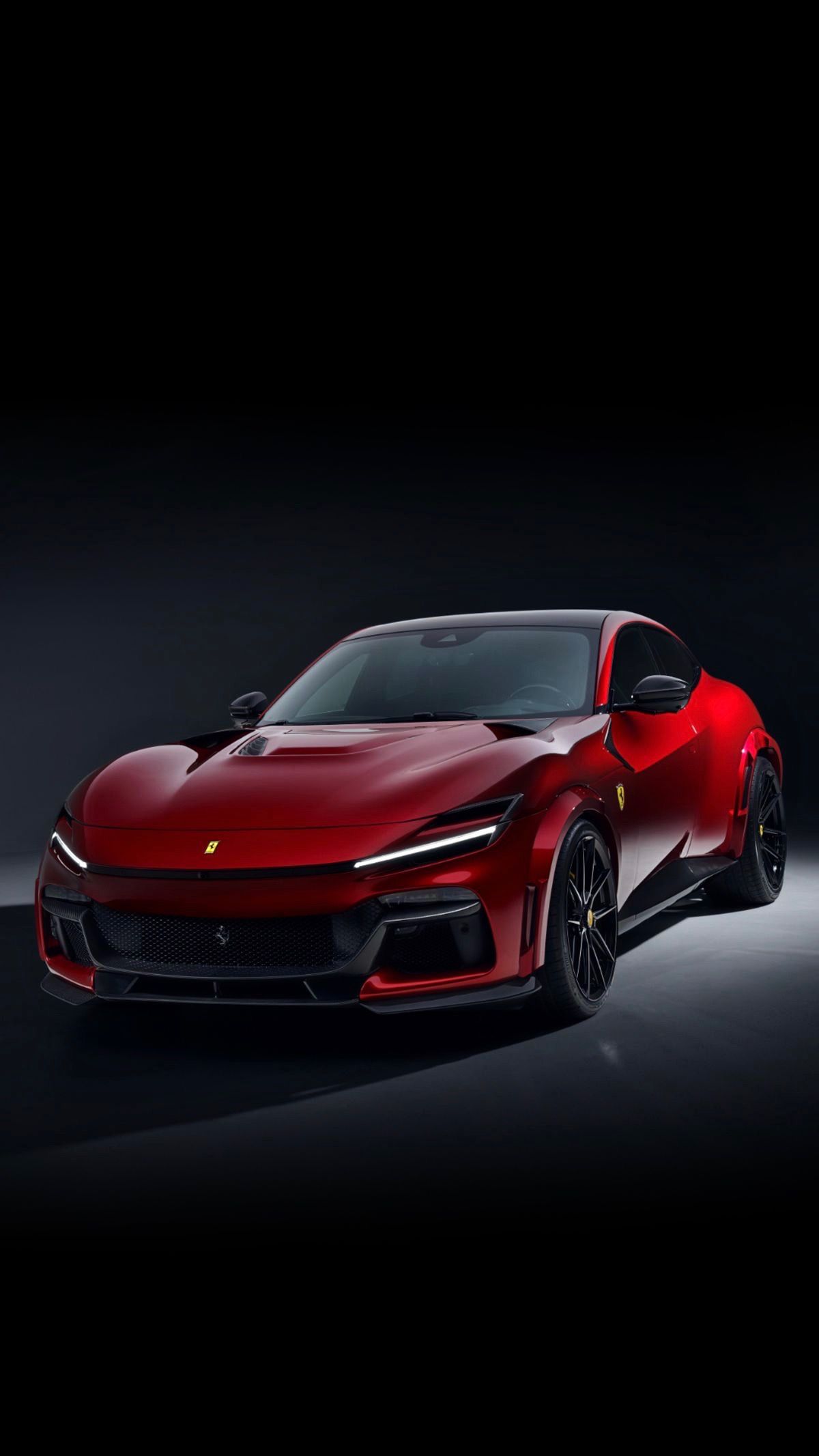 a red sports car is shown in the dark
