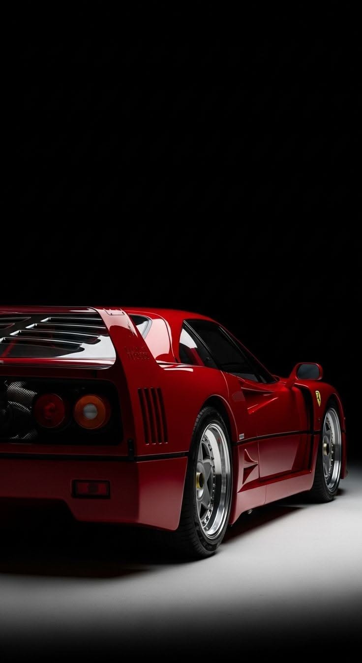 a red sports car is shown in the dark