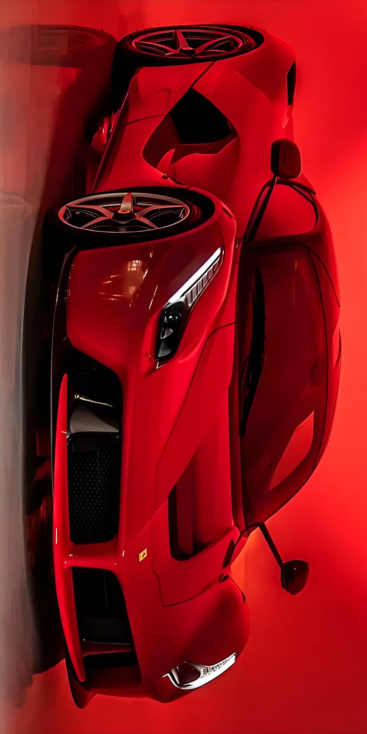 a red sports car parked in front of a wall