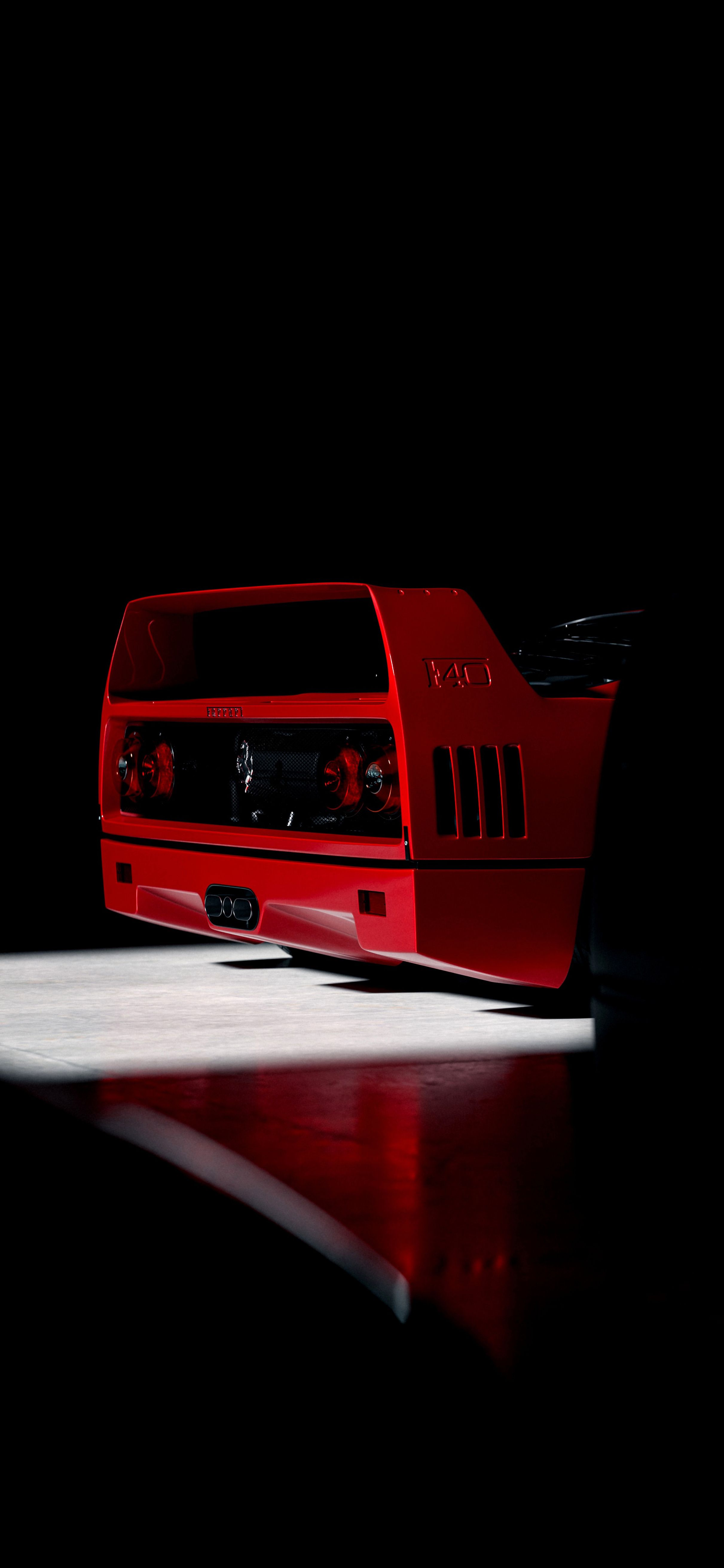 a red sports car parked in the dark