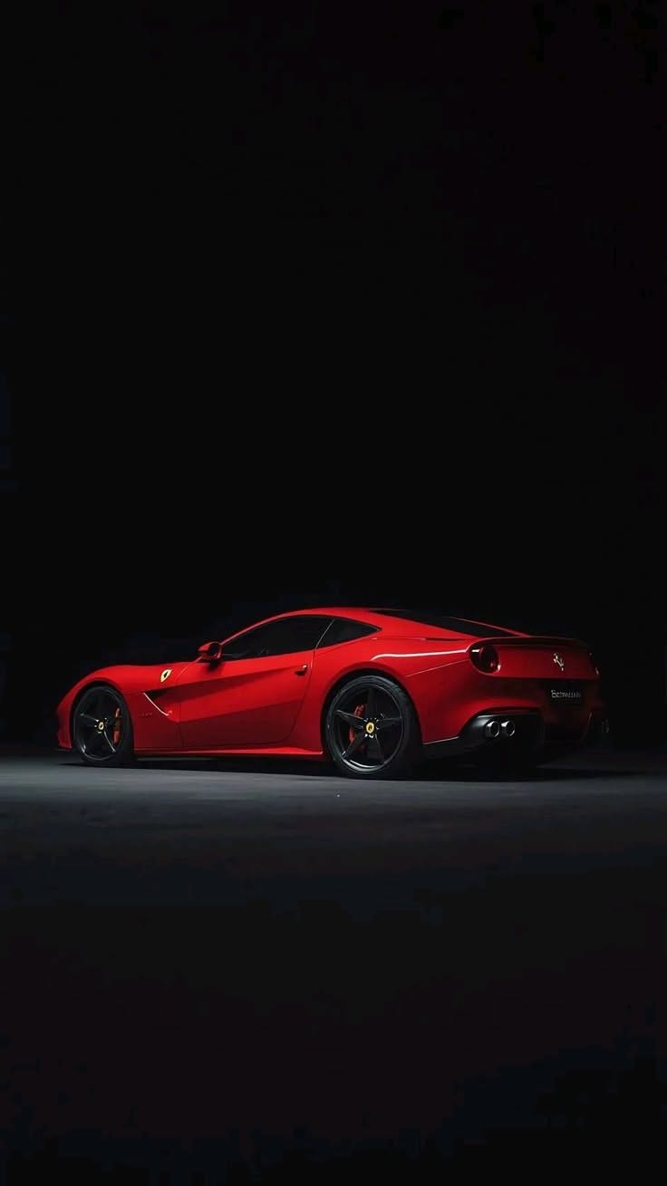 a red sports car parked in the dark