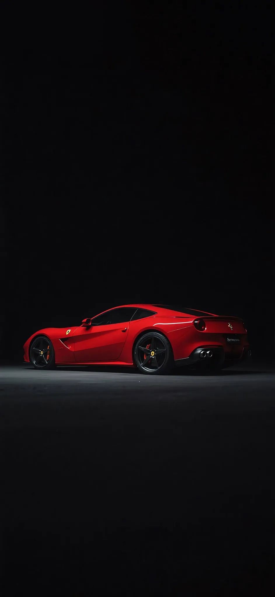 a red sports car parked in the dark