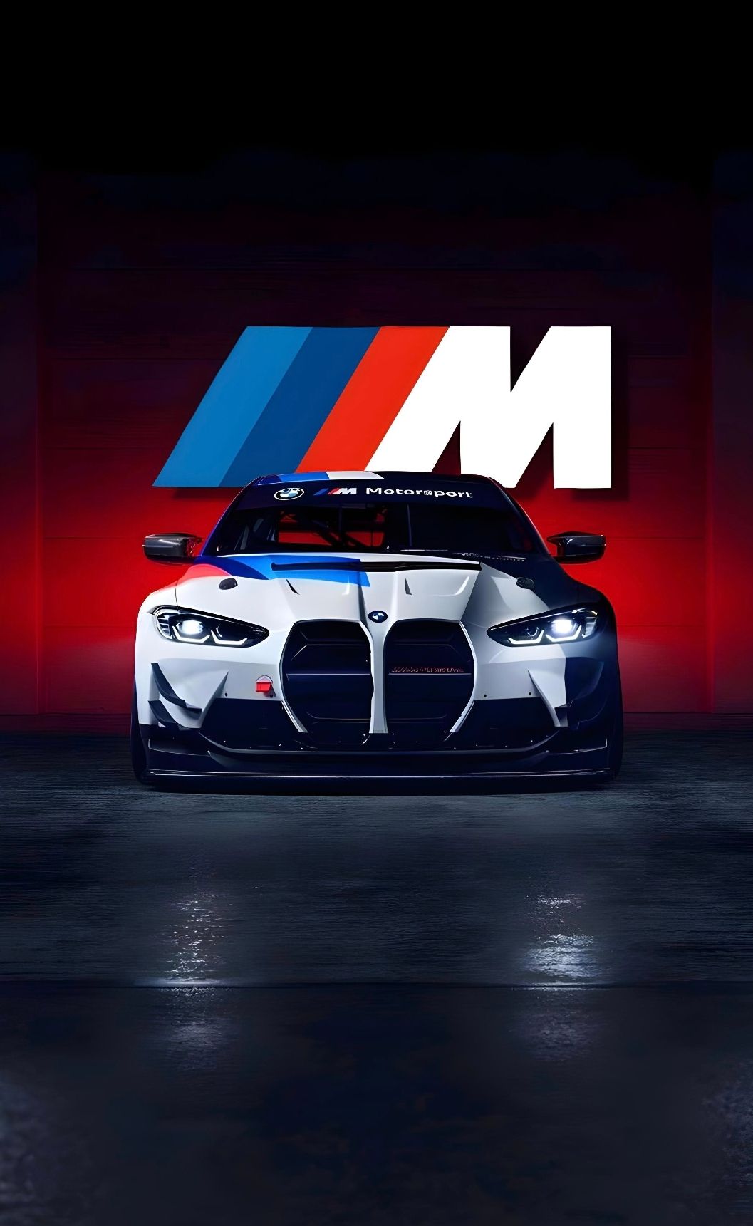a white and blue car is parked in front of a red wall with the m logo on it