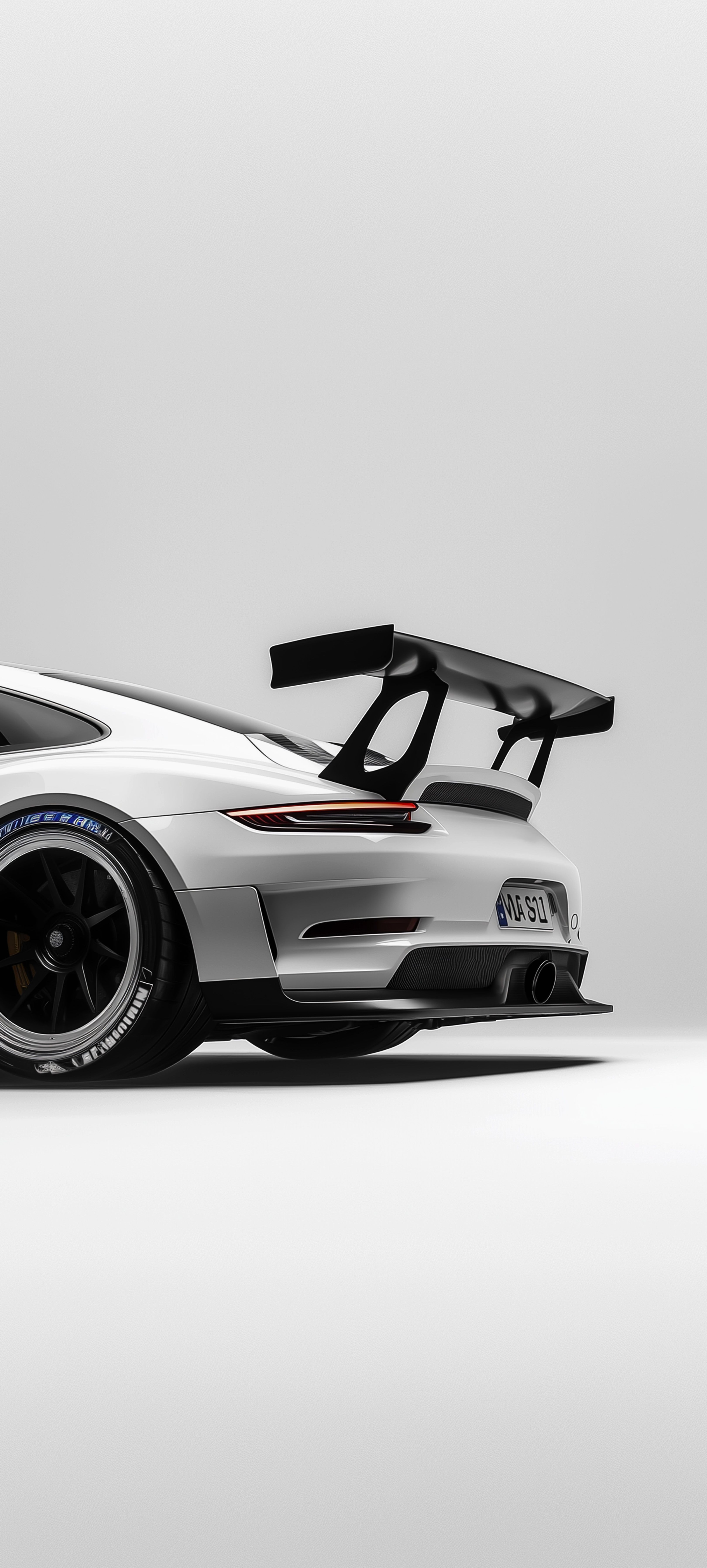 a white porsche sports car with black wheels and an open door on the back end