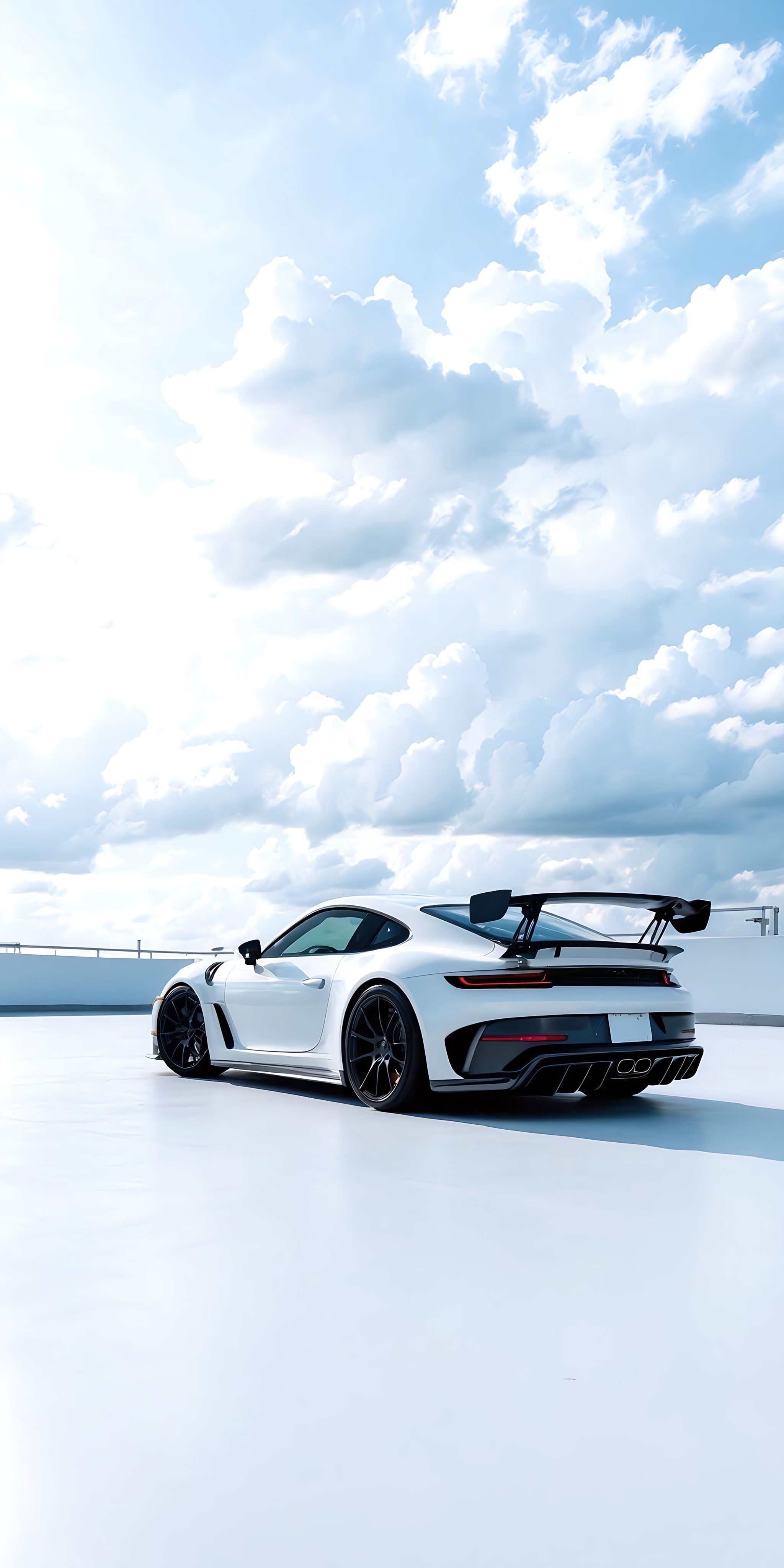 a white sports car parked on top of a snow covered field next to the ocean