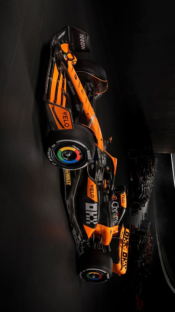 an orange and black race car is shown from above