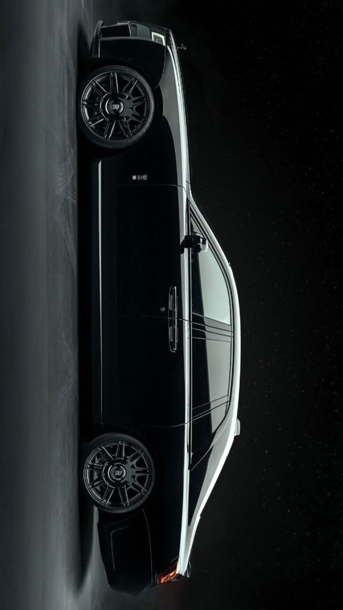 an overhead view of a black and white car in the middle of a dark room