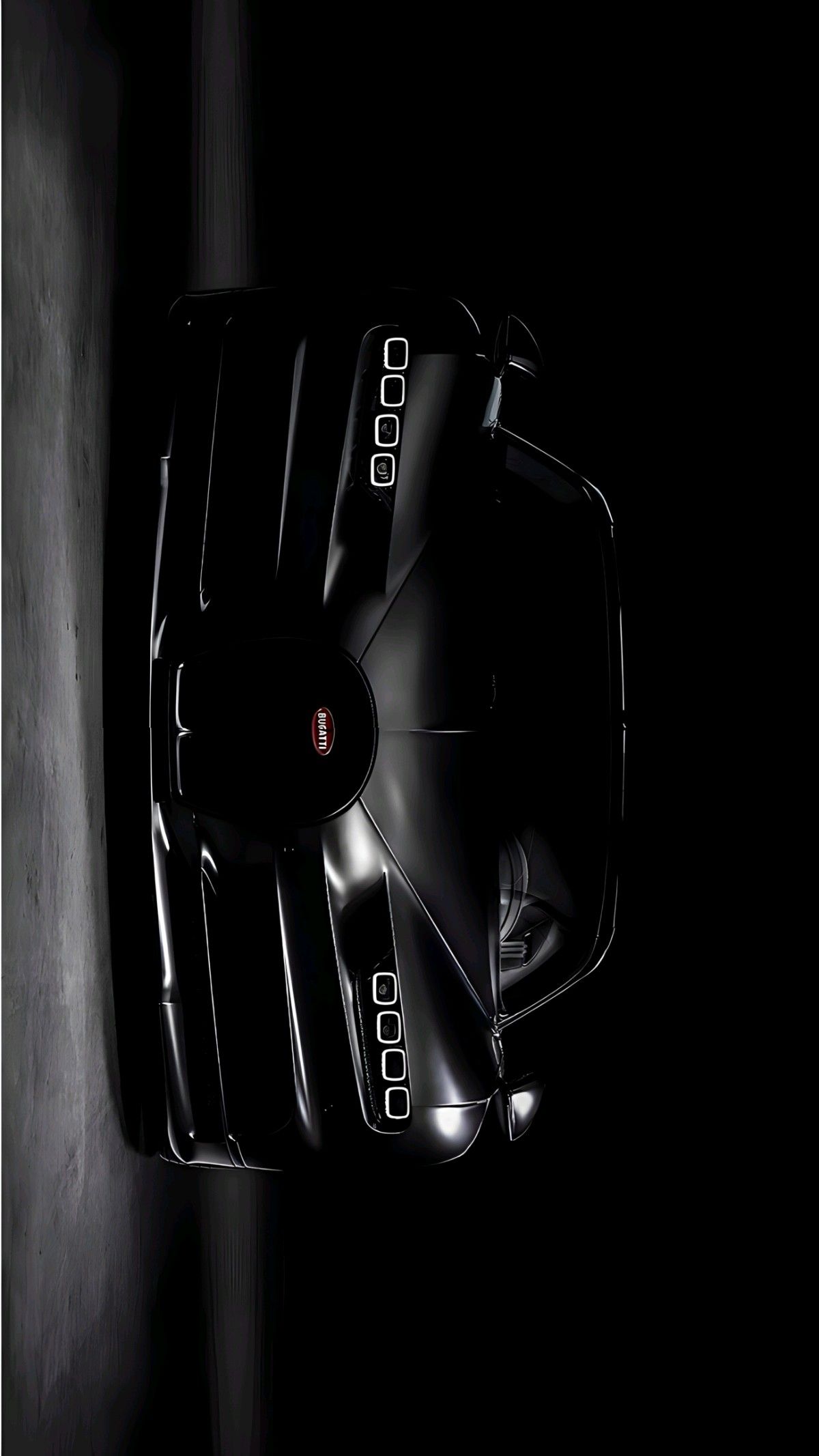 an overhead view of a black sports car in the dark with its hood up and it's lights on