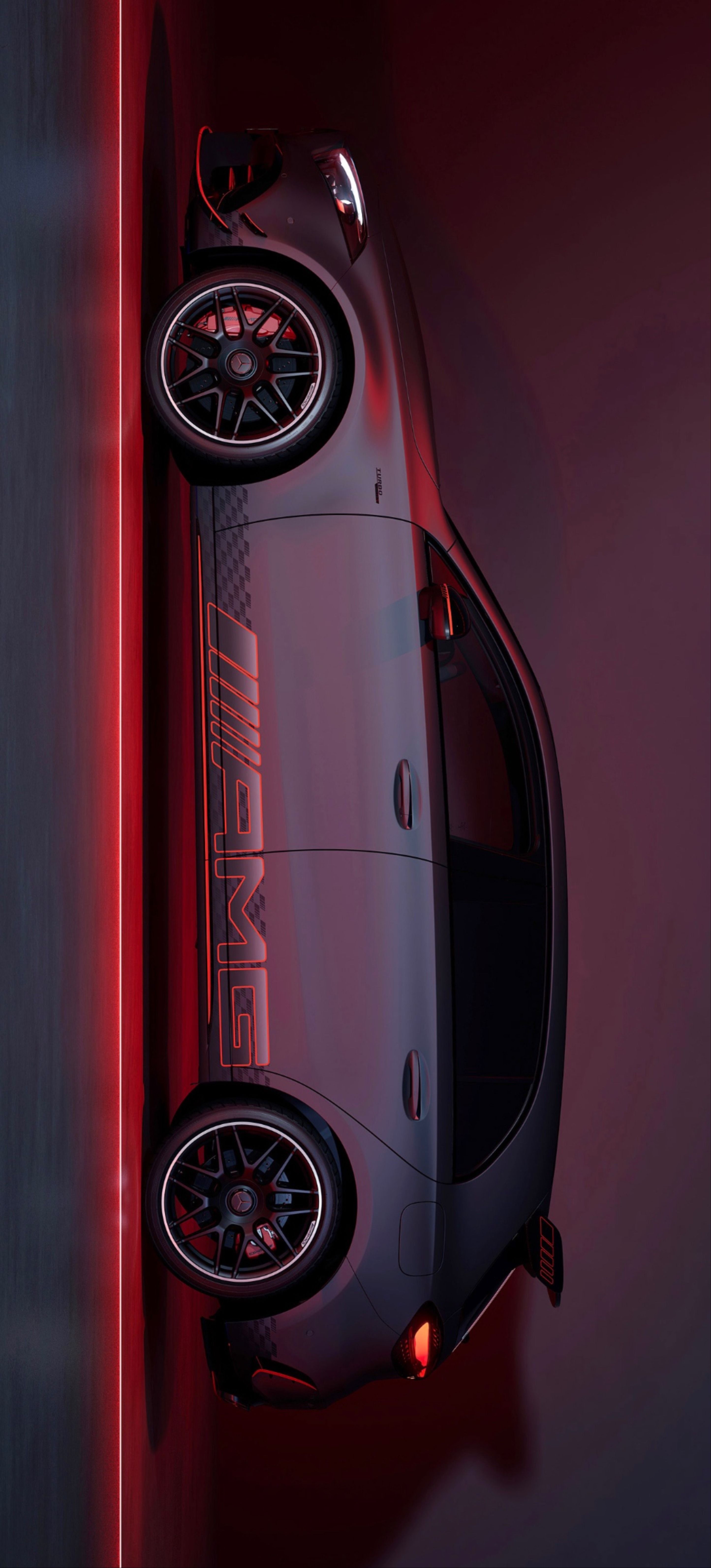 an overhead view of a sports car with its lights on and the door open, in front of a red wall