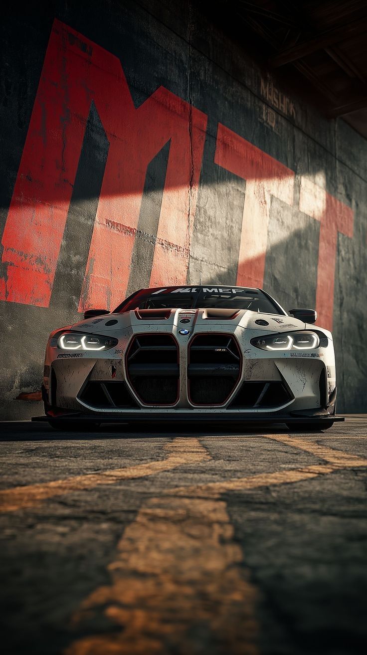 the bmw sports car is parked in front of a wall