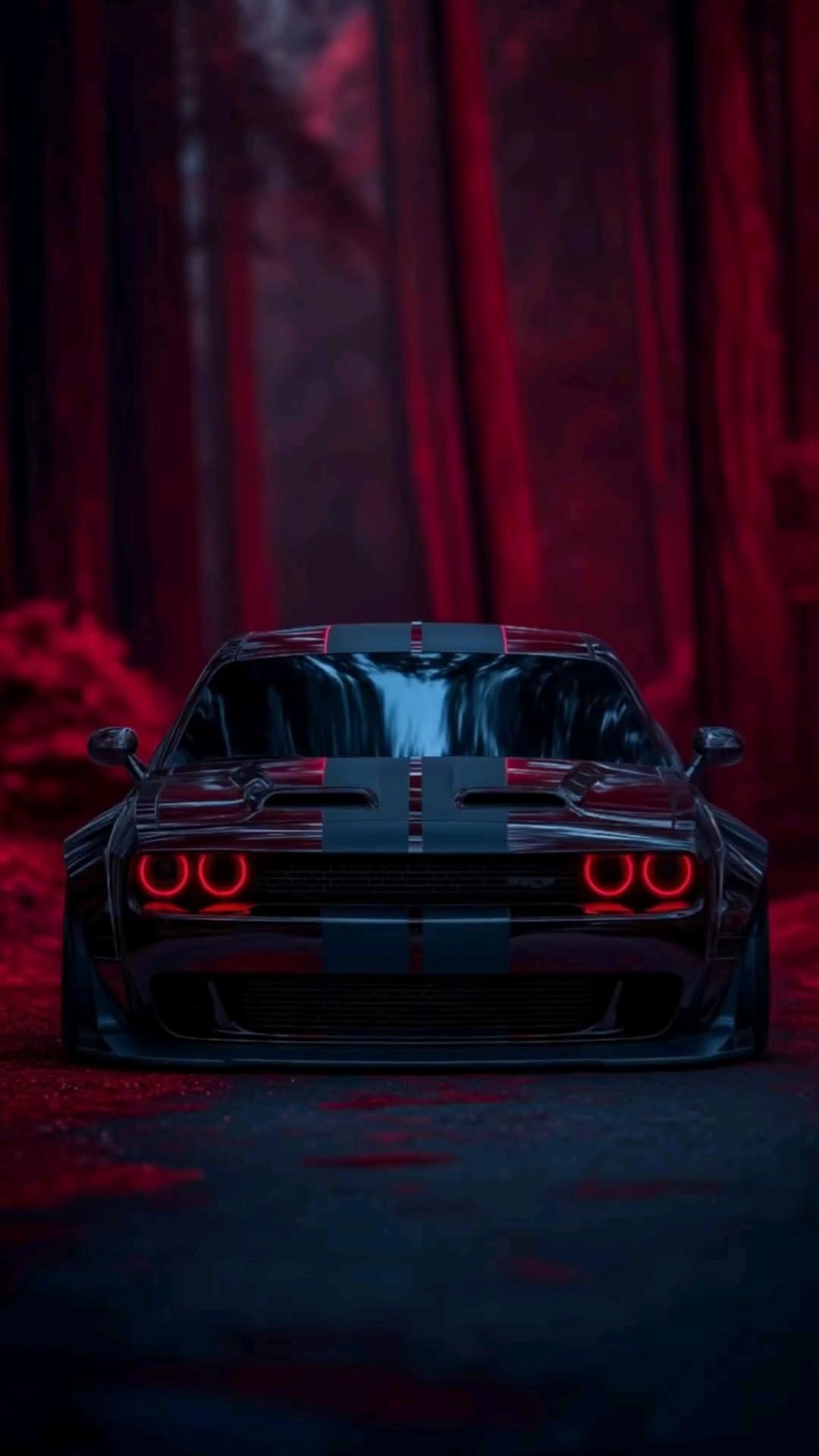 the front end of a black and red sports car with its lights on in a dark forest