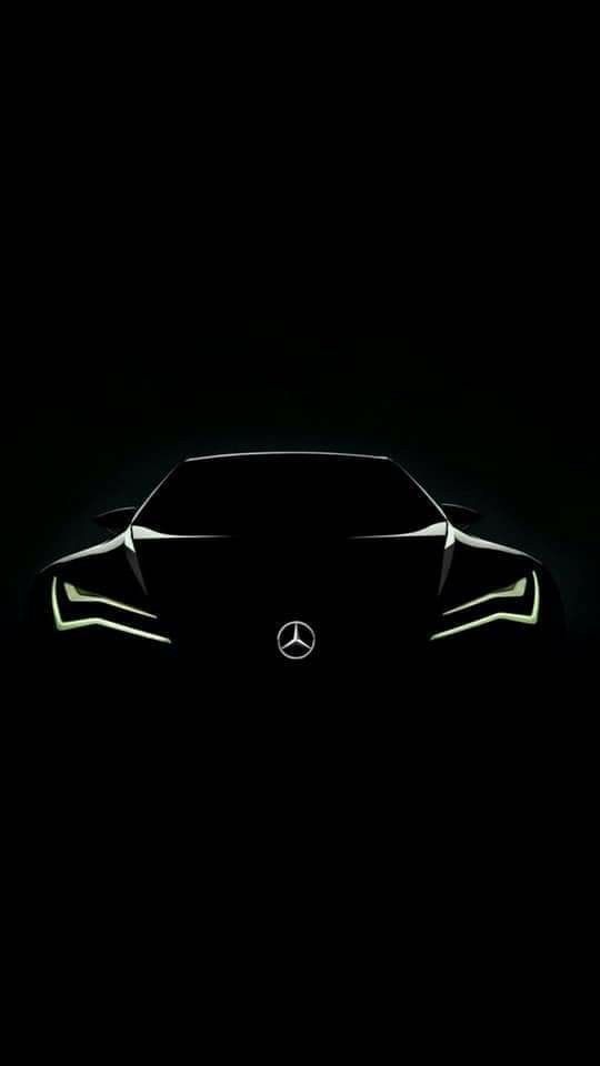 the front end of a black car in the dark