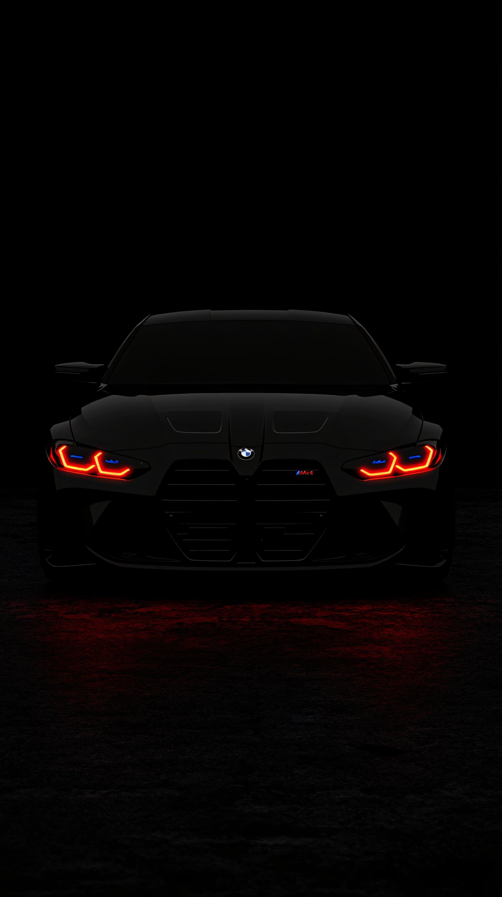 the front end of a black sports car with red lights on it's headlights