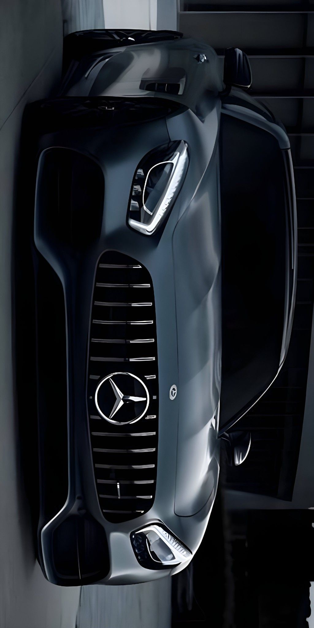 the front end of a mercedes car hanging on a wall in black and white photo