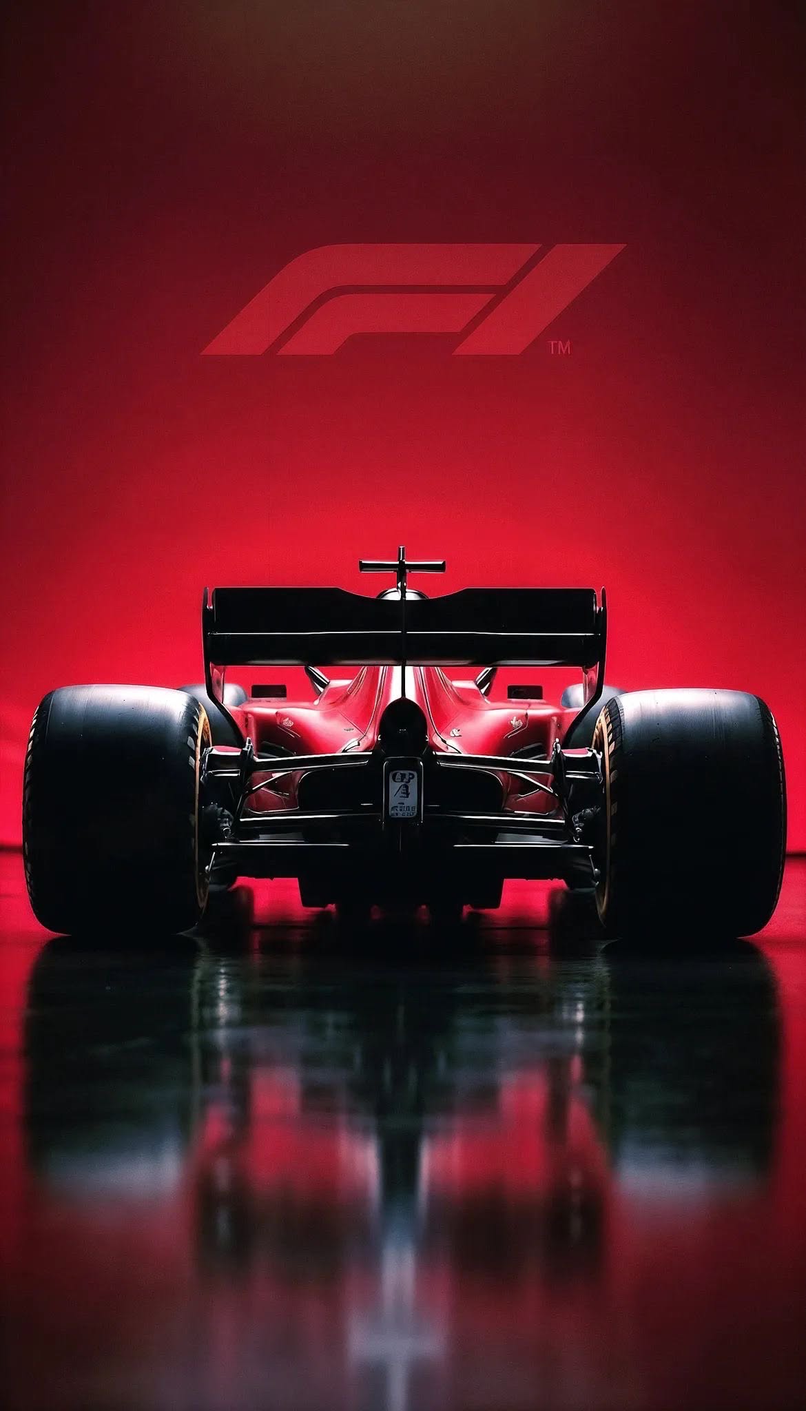 the front end of a racing car on a shiny surface with a red wall in the background