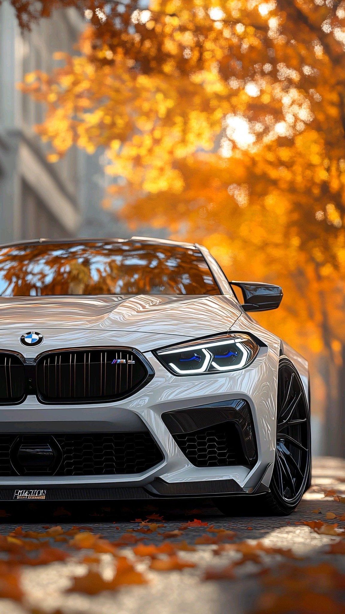 the front end of a white bmw car on a city street with trees in the background