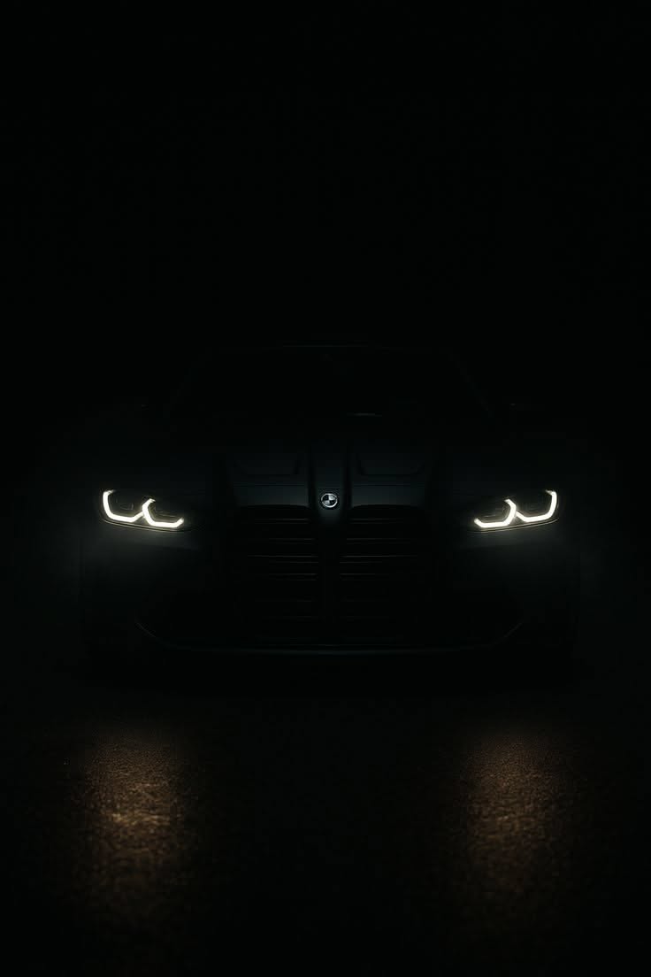 the headlights of a sports car are glowing in the dark