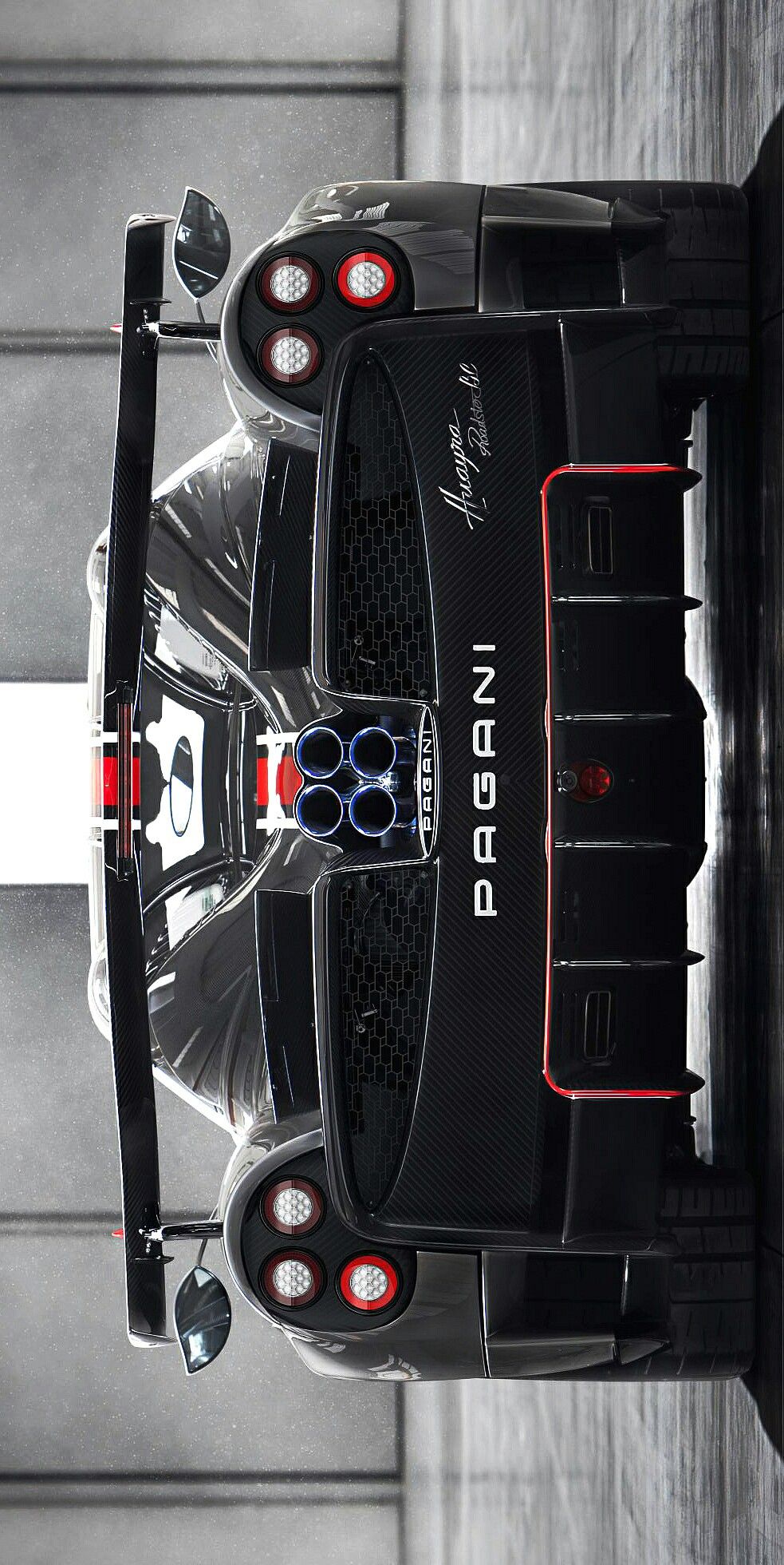 the rear end of a black sports car with red and white stripes on it's tail lights
