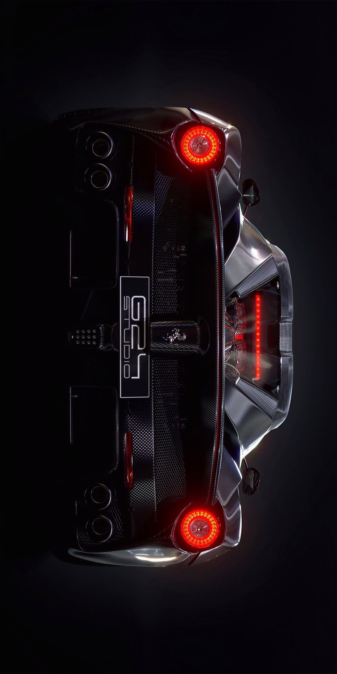 the rear end of a sports car with red lights on it's taillights