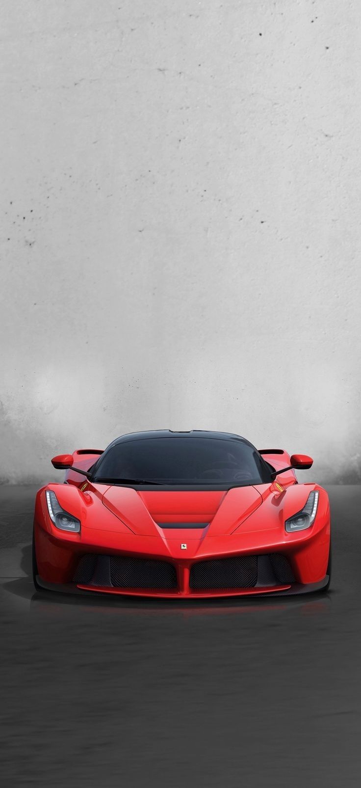 the red sports car is driving down the road