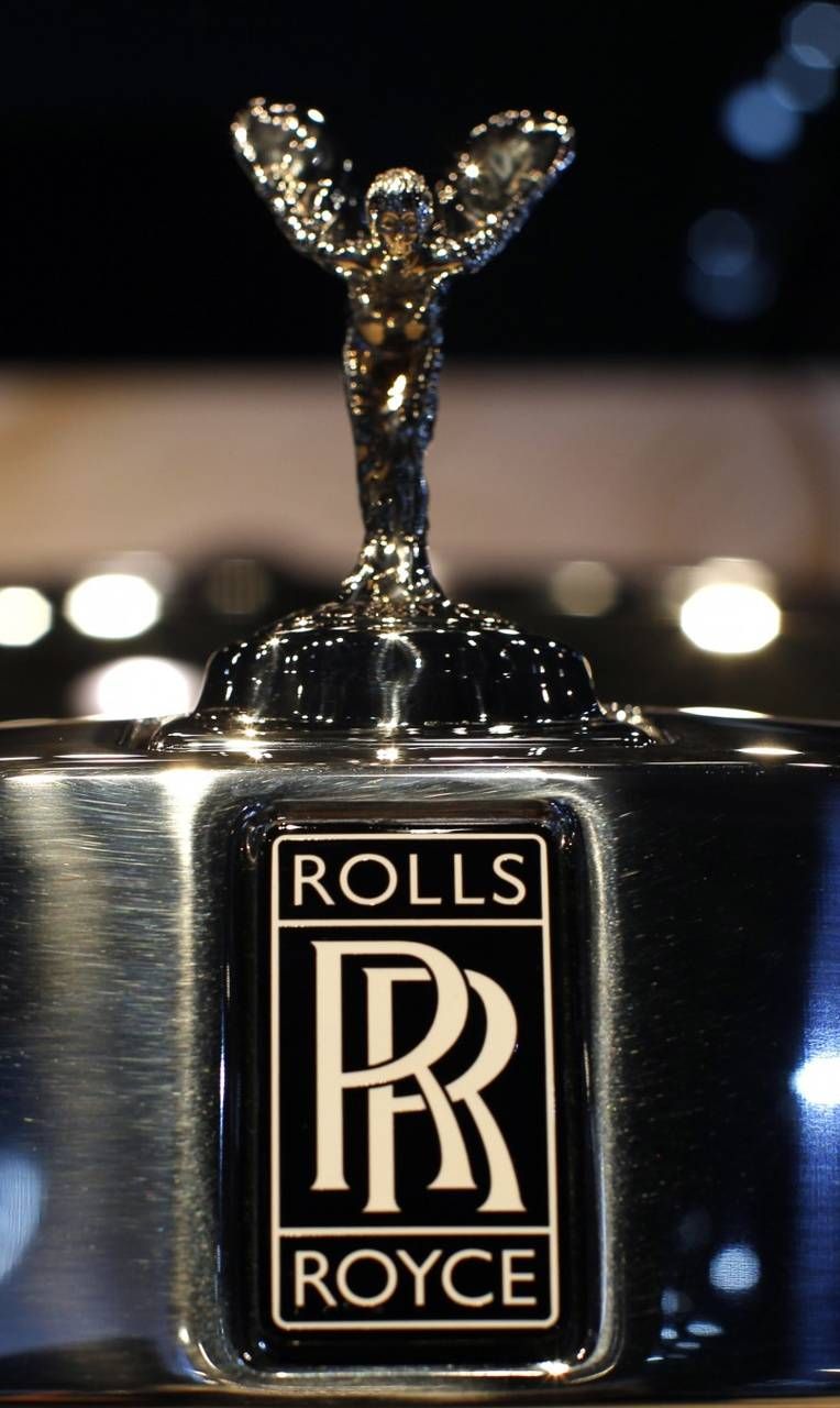 the rolls royce logo is displayed on top of a silver object in black and white
